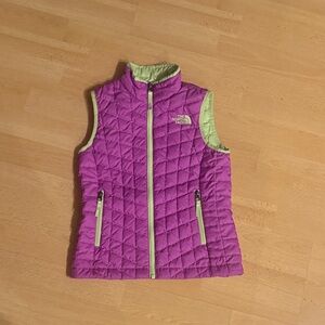 The North Face Thermoball vest for girls, in pink with neon green lining.